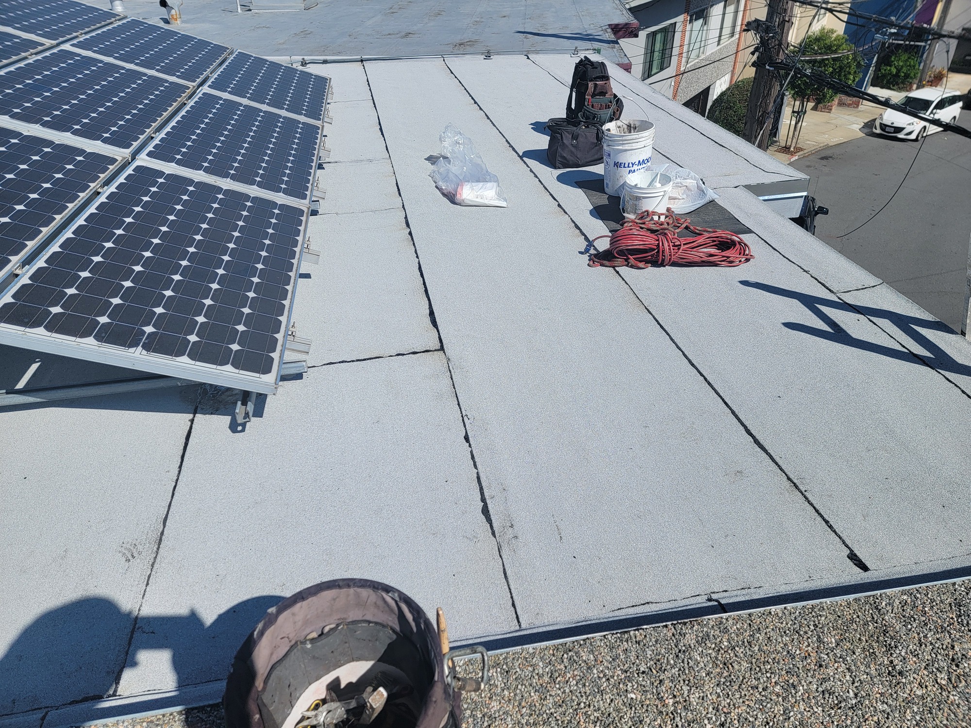 Cap-sheet flat roof installed alongside an existing solar array on a San Francisco home