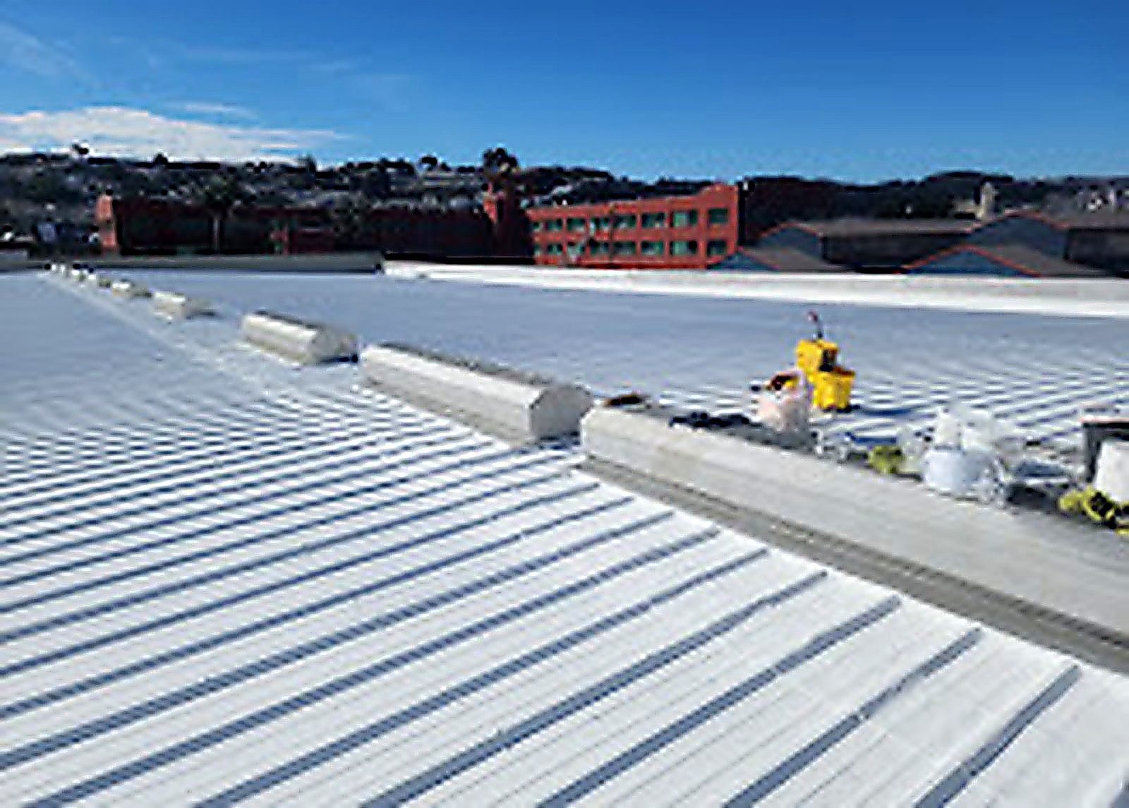 Bright white standing seam metal roof on a large San Francisco building